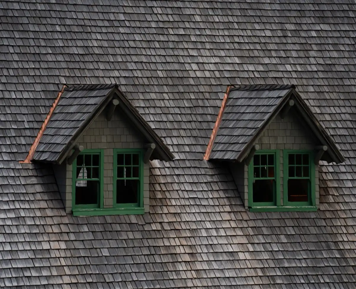 Dormers on a shingle roof in Temecula, CA, where step flashing and kickout flashing carry water past the walls